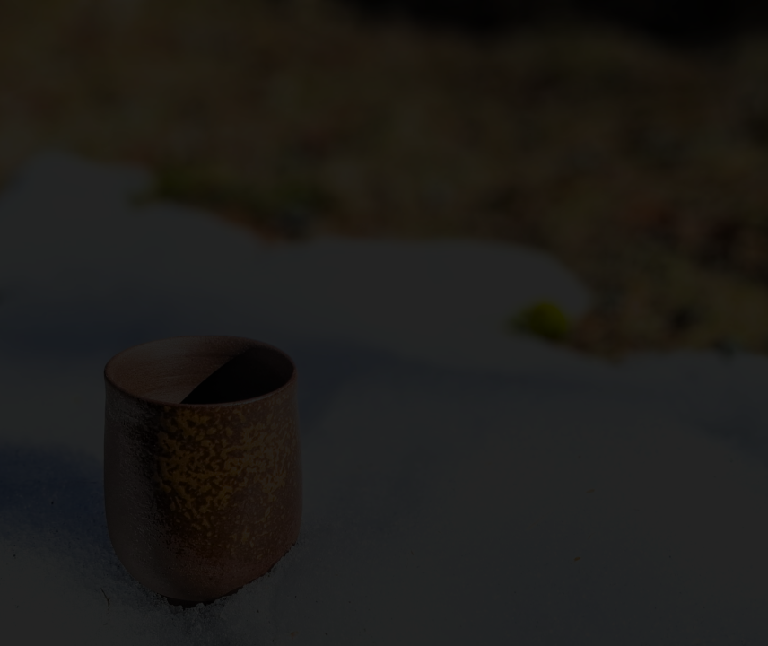 Background image of a Japanese teacup on pile of snow